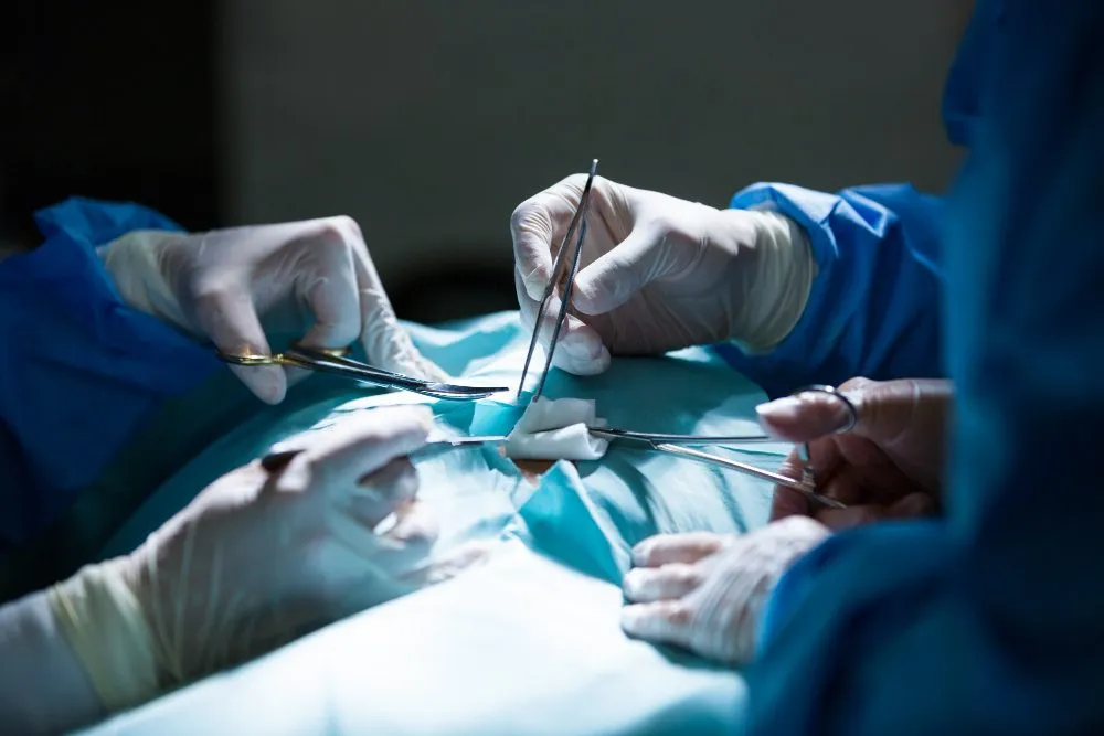Gloved surgeons working with surgical instruments during an operation